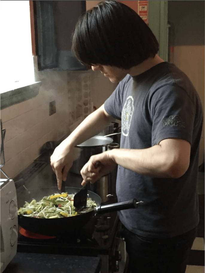 A young person cooking stir fry
